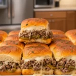 Delicious Philly Cheesesteak Sliders with melted cheese, ground beef, and green peppers on soft slider buns, served in a modern kitchen setting.