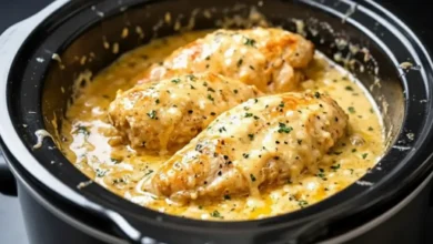 Creamy chicken dinner cooked in a slow cooker with tender chicken breasts simmered in a rich Parmesan cream sauce