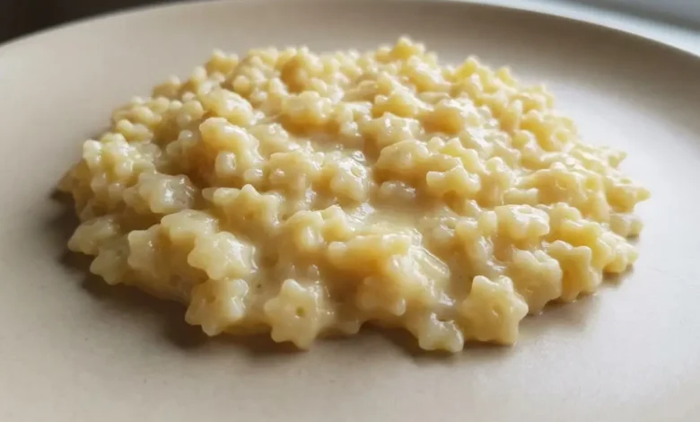 Creamy pastina recipe made with tiny star-shaped pasta, butter, and cheese, served warm on a simple plate