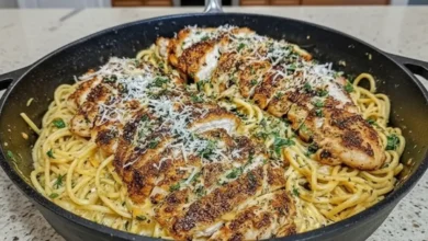 A delicious plate of Garlic Parmesan Spaghetti Cajun Cream with grilled chicken, topped with grated Parmesan and fresh parsley.
